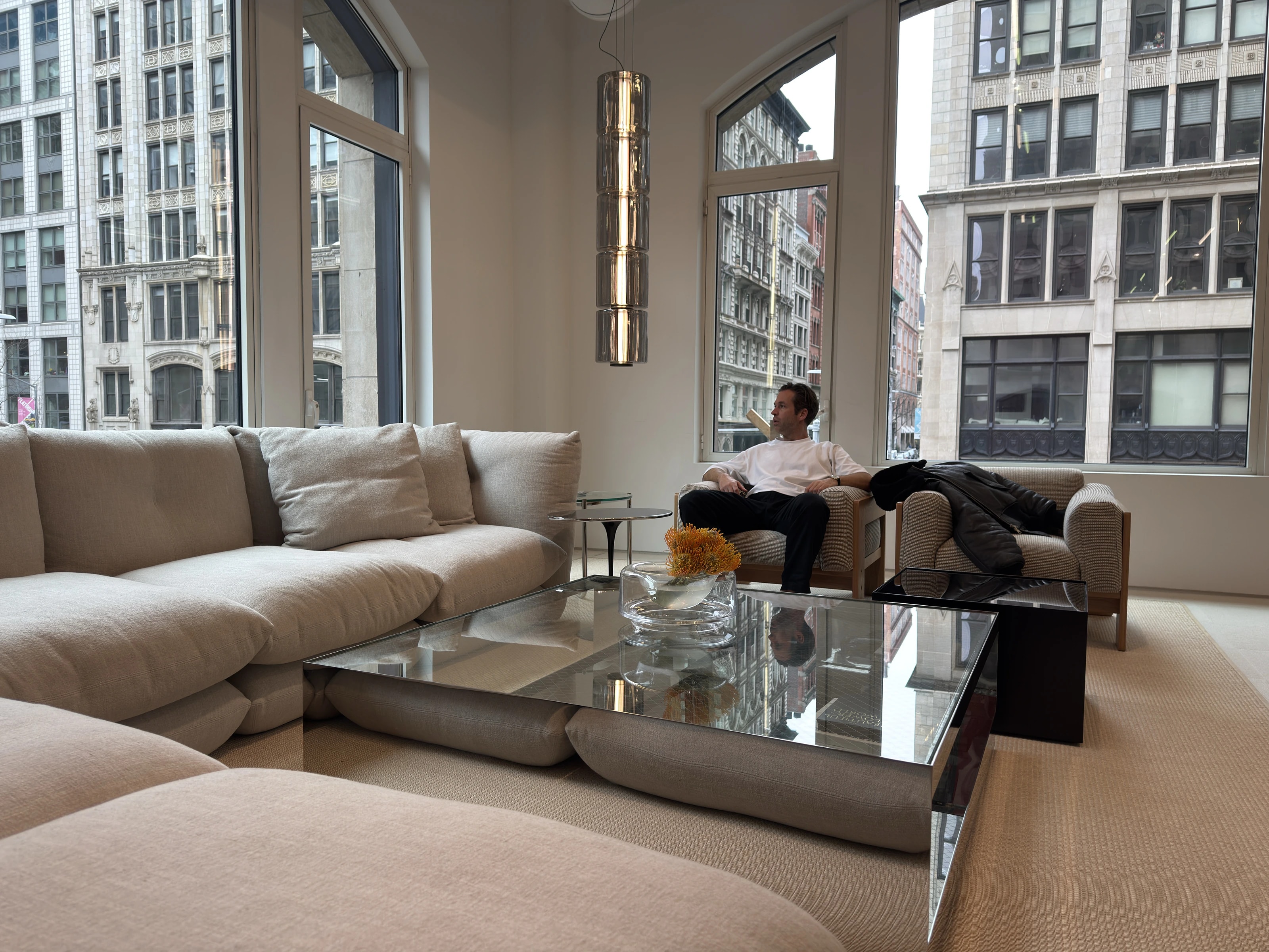 Loft in New York, Tom Canters zit in een fauteuil bij de hoge ramen